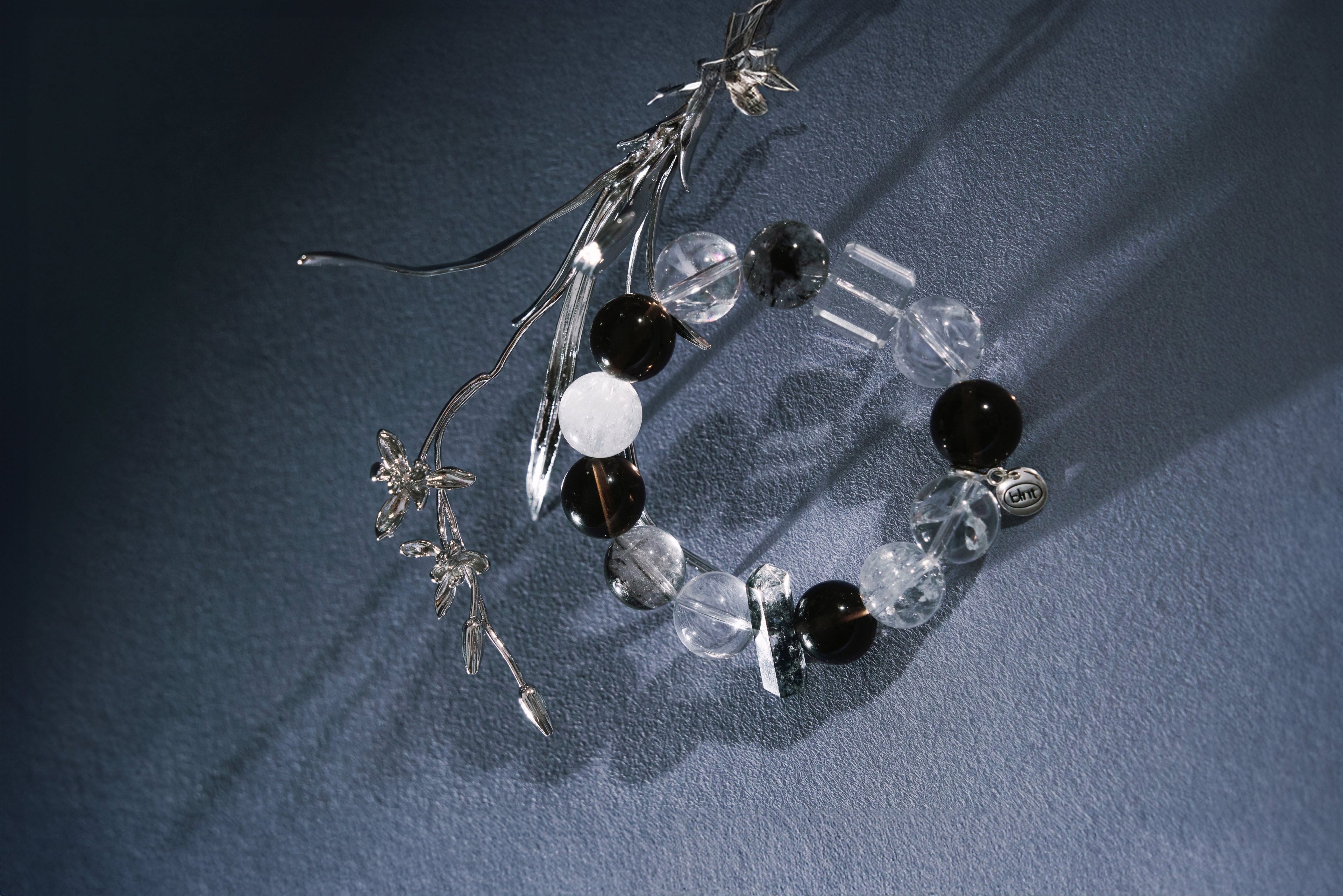 Better Luck Next Time "Equinox" bracelet, black and white crystal beads with rock crystal, herkimer iamond, glacial stone and azeztulite accent pieces, styled hero image.